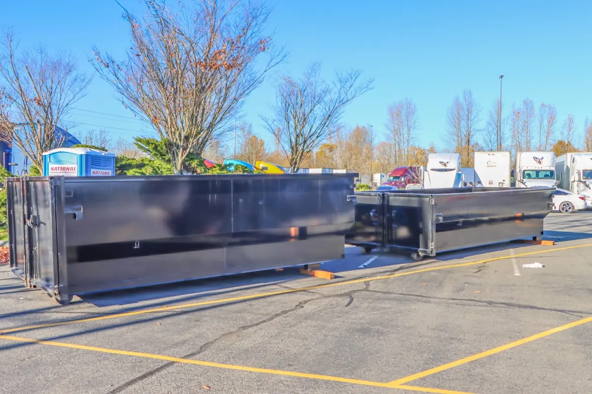 Professional dumpster rental service with roll-off container on residential driveway in Visalia